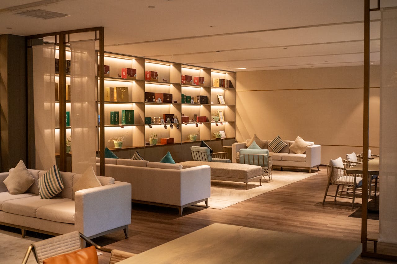 Modern hotel lounge with cozy seating and illuminated shelves in Hangzhou, China.